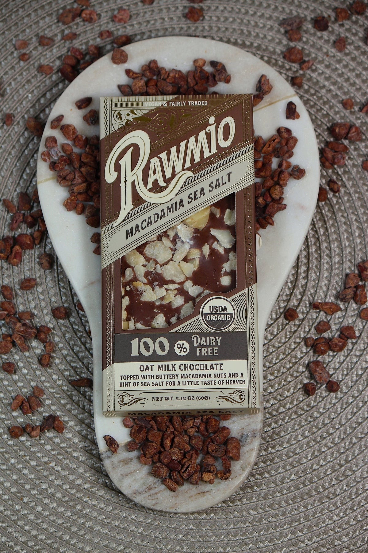 Windy City Organics Rawmio Oat Milk Chocolate Bark, Macadamia Sea Salt styled on a table